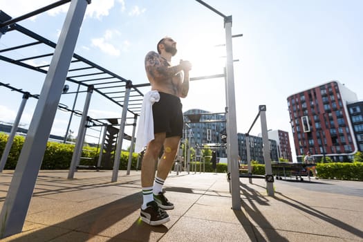 Handsome man doing exercises on the street.