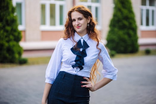 Portrait of a high school student against the backdrop of the school