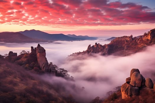 Pink sunset sky among mountains and rocks.