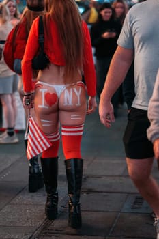 A flamboyant display of New York pride with bold body art on the streets.