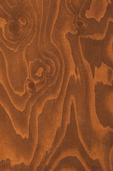 The image captures the rich, warm tones and natural grain patterns of a wooden surface, highlighting the beauty of organic textures