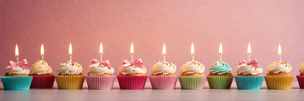 Colorful cupcakes with lit candles are displayed against a pink background, indicating an indoor celebration event marking of joy and celebrating. with free space.