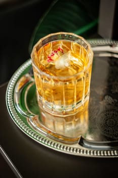 Whiskey in crystal glass with ice cubes and black shadow. High quality photo