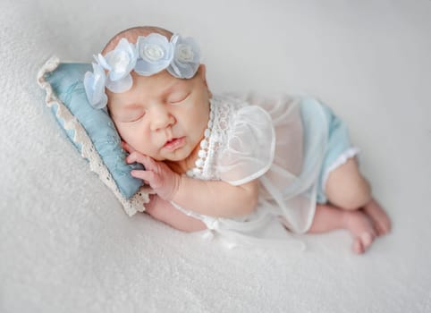 Newborn Girl In Lace Dress Sleeps In White And Blue Tones Photo