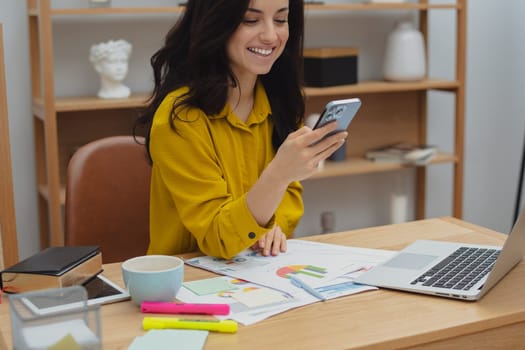 Thoughtful young woman in eyewear using computer while sitting on the sofa at home. High quality photo