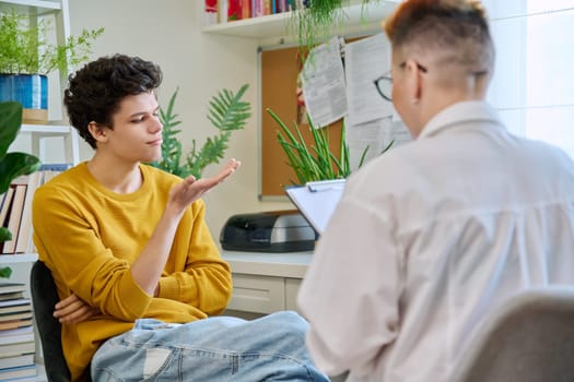 College student guy at meeting with professional counselor, social worker. Youth, mental problems, psychology, psychotherapy, counselling