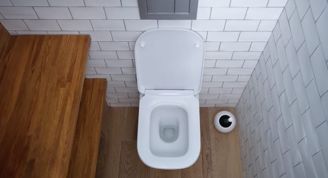 White open ceramic toilet in bathroom. Choice of plumbing in toilet concept