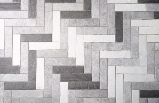 Mosaic floor tiles in rectangles in shades of gray and white. Choice of floor and wall covering concept