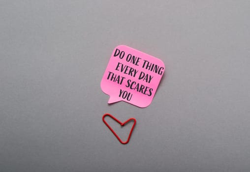 A pink sticky note with the words Do one thing every day that scares you written on it