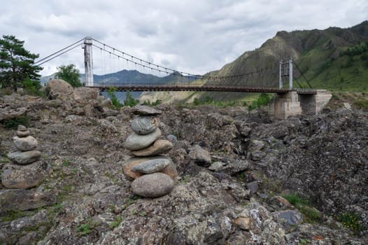 Fast mountain river Katun and Oroctoy bridge in Altay, Siberia, Russia.