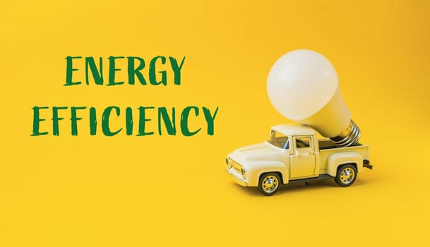 A white truck with a light bulb on top of it. The words energy efficiency are written below the truck