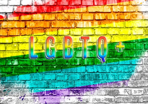 A rainbow colored brick wall with the word LGBT written on it. The rainbow colors and the word LGBT convey a sense of inclusivity and diversity