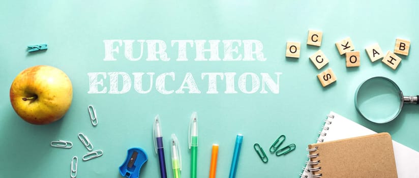 Further education is important for personal and professional growth. A green background with a green apple, a pair of scissors, a pair of blue pens, and a pair of red pens