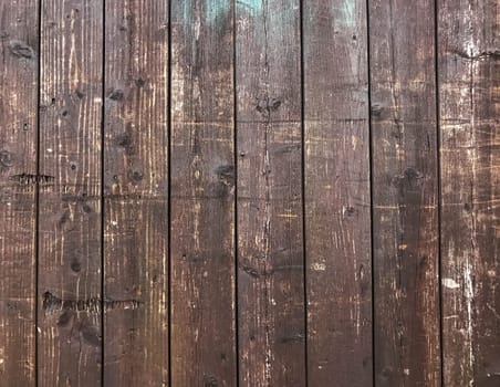 A wooden background with a lot of scratches and marks. The wood is old and worn, giving the image a rustic and aged feel