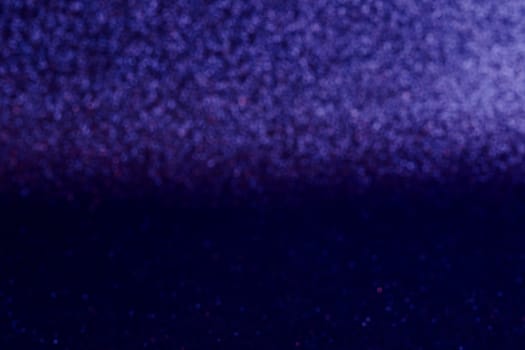 A blurry image of a blue background with purple and red dots. The image has a dreamy, ethereal quality to it