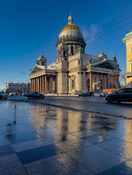 incredible reflection in spring puddles of St. Isaac's Cathedral in St. Petersburg - Russia at sunny eather. High quality photo