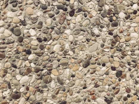A rocky surface with a variety of sizes and shapes of rocks. The rocks are scattered all over the surface, creating a rough and uneven texture. Concept of ruggedness and natural beauty