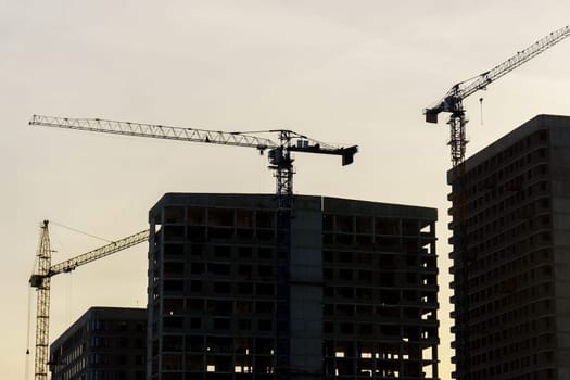 Construction crane at a construction site. Construction of new houses