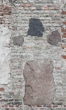 Medieval wall made of bricks and stone. Abstract background.