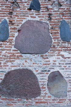 Medieval wall made of bricks and stone. Abstract background.