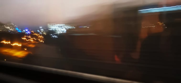 Conceptual shot of the light trails captured from the window of the moving train