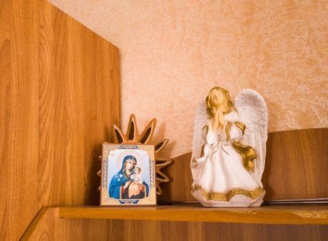 Concept shot of a little angel figurine and icon