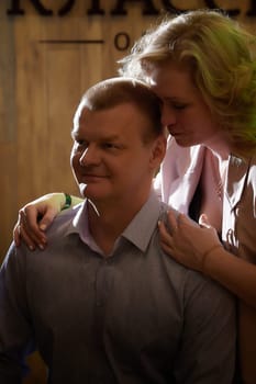 Adult man and woman are conversing on stage in dimly lit room before a performance or interview. The actors, actress, host, journalist, and paparazzi capturing their intimate, secretive conversation