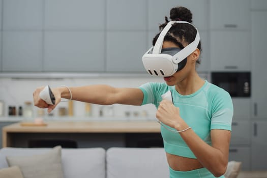 Training to become the best. Beautiful young woman in sports clothing exercising at home.