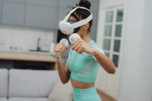 Training to become the best. Beautiful young woman in sports clothing exercising at home.