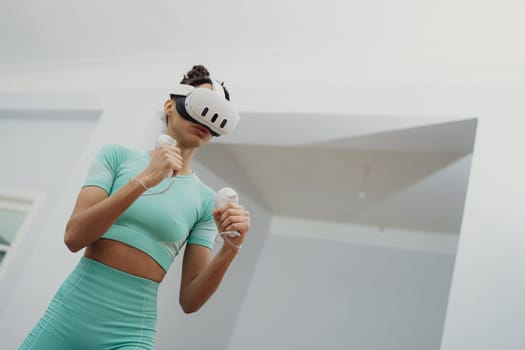 Training to become the best. Beautiful young woman in sports clothing exercising at home.