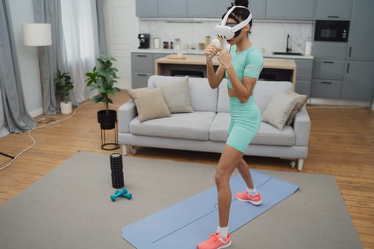 Training to become the best. Beautiful young woman in sports clothing exercising at home.