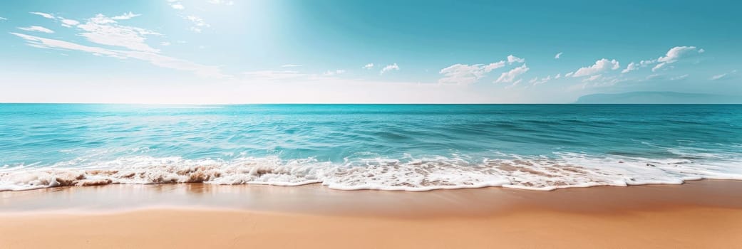 A beautiful ocean view with a clear blue sky. The water is calm and the waves are gentle. The beach is sandy and stretches out into the distance. The scene is peaceful and relaxing