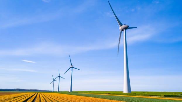 A mesmerizing sight of wind turbines standing tall in a vast field, gracefully spinning under the Spring sun in the Netherlands Flevoland. windmill turbines, green energy, eco friendly, earth day