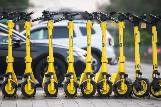A lot of electric kicksharing from Yandex go, ready for rent. choice between types city transport, electric scooter or personal car. Almaty, Kazakhstan - June 11, 2023