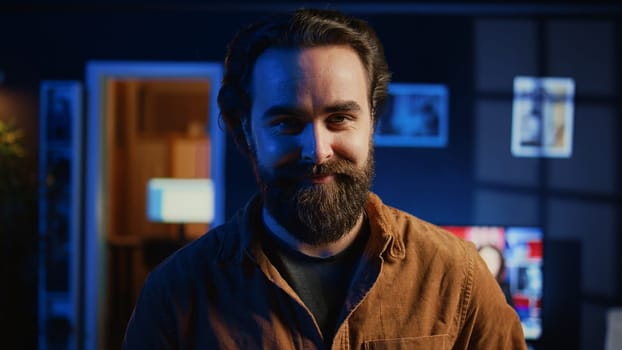 Portrait of smiling developer writing complex binary code scripts on laptop terminal. Cheerful remote IT employee standing in home office, using programming to safeguard consumer data, camera B