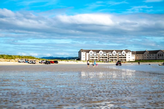 DOWNINGS, IRELAND - JULY 31 2022: Holiday makers enjoying the beach.