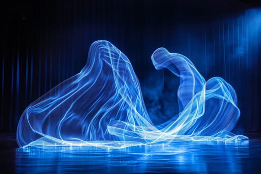 A blue wave of light is projected onto a dark background. Concept of movement and energy, as if the light is flowing through the air. The blue color of the wave adds a calming