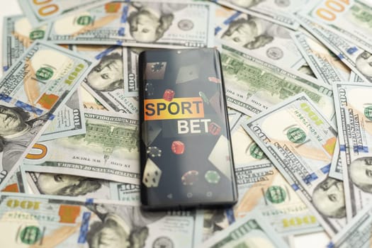 Smartphone with gambling mobile application with money close-up. Sport and betting concept. High quality photo