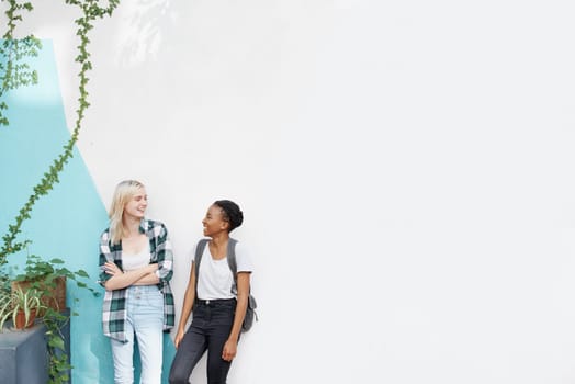 Happiness, girl and students on break with conversation for catch up, socializing and teenagers with mockup space. Female people or friends, communication and university for education and talking