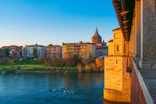 Panorama of Ponte Coperto (covered bridge) and Duomo di Pavia (Pavia Cathedral) in Pavia at sunny day, Lombardy, italy.