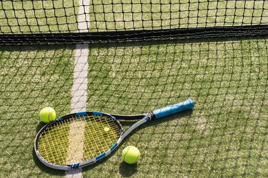 tennis racket with balls on green background. High quality photo