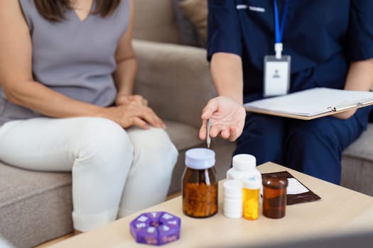 doctor give advice about medicine or vitamin to elderly woman come for checkup at the clinic.