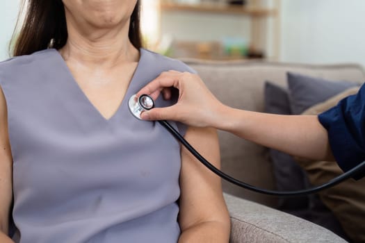 cardiologist visit elderly patient at home. cardiologist use stethoscope to listen to heart rate of elderly patient.