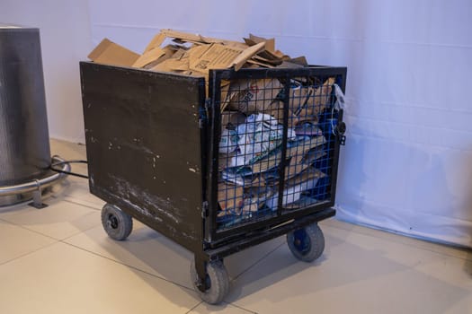 TURKEY, ISTANBUL, 9 AUGUST, 2022: Garbage and trash in cart trolley at hallway building in airport Istanbul. Turkey.