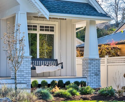 Luxury family house with swinging bench on the open patio.