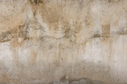 Old water damaged grey plaster wall surface with yellow smudges. Full-frame flat background and texture.