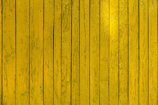 yellow paint wooden planks fence texture.