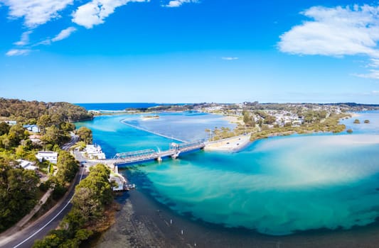 Aerial view of the idyllic coastal town of Narooma wrapped around the famous Wagonga Inlet in South Coast, New South Wales, Australia
