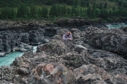 Woman at the river Katun at summer day. Trip on Altai Mountains in Altai Republic