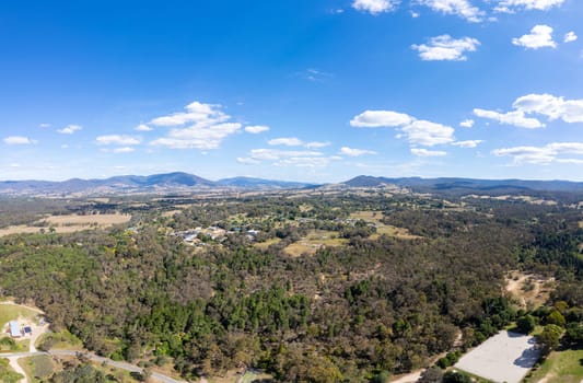 YACKANDANDAH, AUSTRALIA- DECEMBER 29 2023: An aerial view of the historic gold mining town of Yackandandah towards bright and the mountains on a warm summers day in Victoria, Australia
